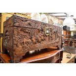(HP) An Oriental carved camphor wood coffer, 80cm wide.