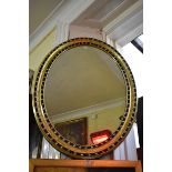 A pair of decorative Irish style gilt and ebonized framed oval wall mirrors, 105 x 79cm.