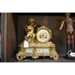(HP) A late 19th century French gilt brass and porcelain mounted figural mantel clock, 28cm high,