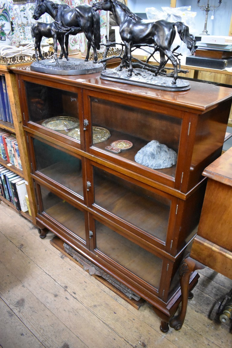 A early 20th century mahogany three tier sectional bookcase, 102.5cm wide.