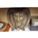 A composition stone satyr mask wall mount, 43cm wide.