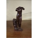 After the antique, a bronze sculpture of a female nude, inscribed Athos, 17cm high.