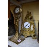 A late 19th century French gilt brass mantel clock, 34cm high, with pendulum; together with an Art