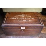 An unusual hardwood casket, the hinged top inscribed 'RAF Briefing Room Tea Caddy', 33cm wide.