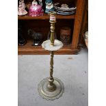 A large antique Continental brass candlestick, 70cm high.