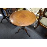 A George III mahogany circular tripod table, the dished one piece top revolving on a birdcage