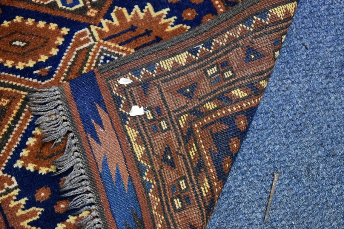 A small Persian rug, having floral decoration with hearts to central field on a blue and orange - Image 3 of 3