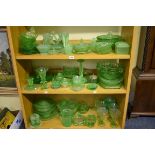A large collection of green uranium glass. (Three shelves)
