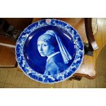 A Dutch Delft blue and white charger, painted with 'Girl with a Pearl Earring', after Jan Vermeer,