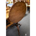 A George III mahogany revolving circular tilt-top tripod table, with one piece top, 64cm diameter.