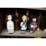 Five novelty ceramic figural spirit flasks and stoppers; together with a similar tea canister and