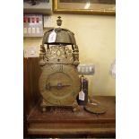 An antique brass lantern clock, with 6 1/4in dial and single hand, 38.5cm high, with weight and