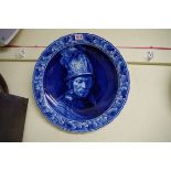 A Dutch Delft blue and white charger, painted with 'The Man in a Golden Helmet', after Rembrandt,