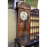 An early 20th century oak Vienna style wall clock, by Gustav Becker, with pendulum and two weights.