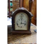 A 1920s mahogany mantel clock, chiming on four straight gongs, 21cm high.