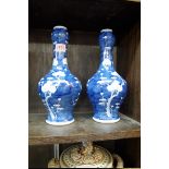 A pair of Chinese blue and white garlic neck vases, Kangxi four character marks, 29cm high.