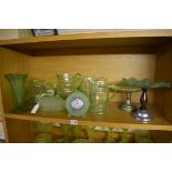 A collection of green uranium glass. (one shelf)
