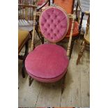 A Victorian carved walnut and button upholstered nursing chair.
