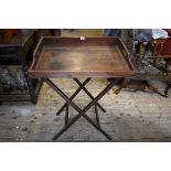 A 19th century mahogany butlers tray, 70cm wide, on folding stand.