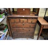 An antique oak chest of drawers, with unusual brass figural escutcheons, 78cm wide, (in two parts).