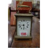 An old brass carriage timepiece, height including handle 15cm.
