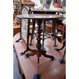 An antique mahogany circular tripod table, 61cm diameter.