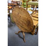 A George III oak circular tilt-top tripod table, 81cm diameter.