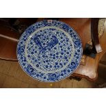 A Dutch Delft blue and white charger, painted with two birds amidst stylised foliate scrolls, 42cm