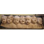 A plaster relief plaque of singing children, 69.5 x 22.5cm.