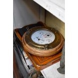 A novelty brass and oak framed ship's porthole combined clock and barometer, 35cm diameter; together