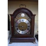 An Elliott mahogany mantel clock, striking on eight straight gongs, height including handle 36.5cm.