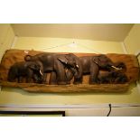 A carved wood elephant plaque, 119cm wide.
