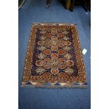 A small Persian rug, having floral decoration with hearts to central field on a blue and orange