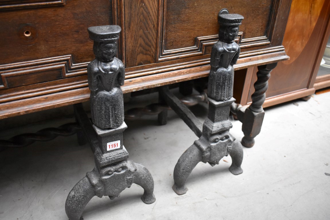 An early pair of cast iron figural fire dogs, 50cm high.