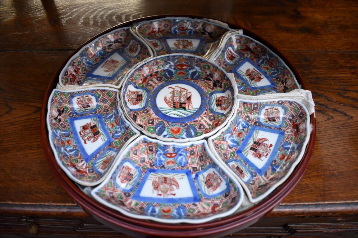 A Chinese Imari seven piece hors d'oeuvres set, in lacquer circular box and cover, 33cm diameter.