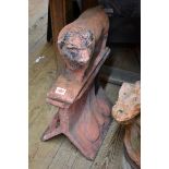 A red composition stone Bull roof ridge tile, 37.5cm wide.