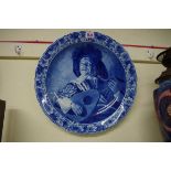 A Dutch Delft blue and white charger, painted with 'The Serenade', after Judith Leyster, 41cm