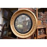 An old gilt painted circular wall mirror, 59.5cm diameter.