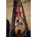 An eight string mandolin, labelled 'Carlo Guiseppe Picino', in case.