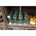 A matched set of twelve antique Continental green glass roemers.