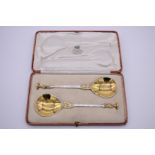 A cased pair of silver gilt apostle spoons, by William Hutton & Sons Ltd, London 1911. 19cm, 143g.