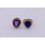 A lapis lazuli oval cabochon dress ring; together with a similar amethyst set example, both