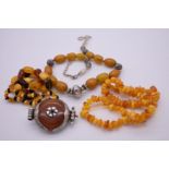 A small collection of tumbled Baltic amber beaded necklaces; together with a large Ethnic amber