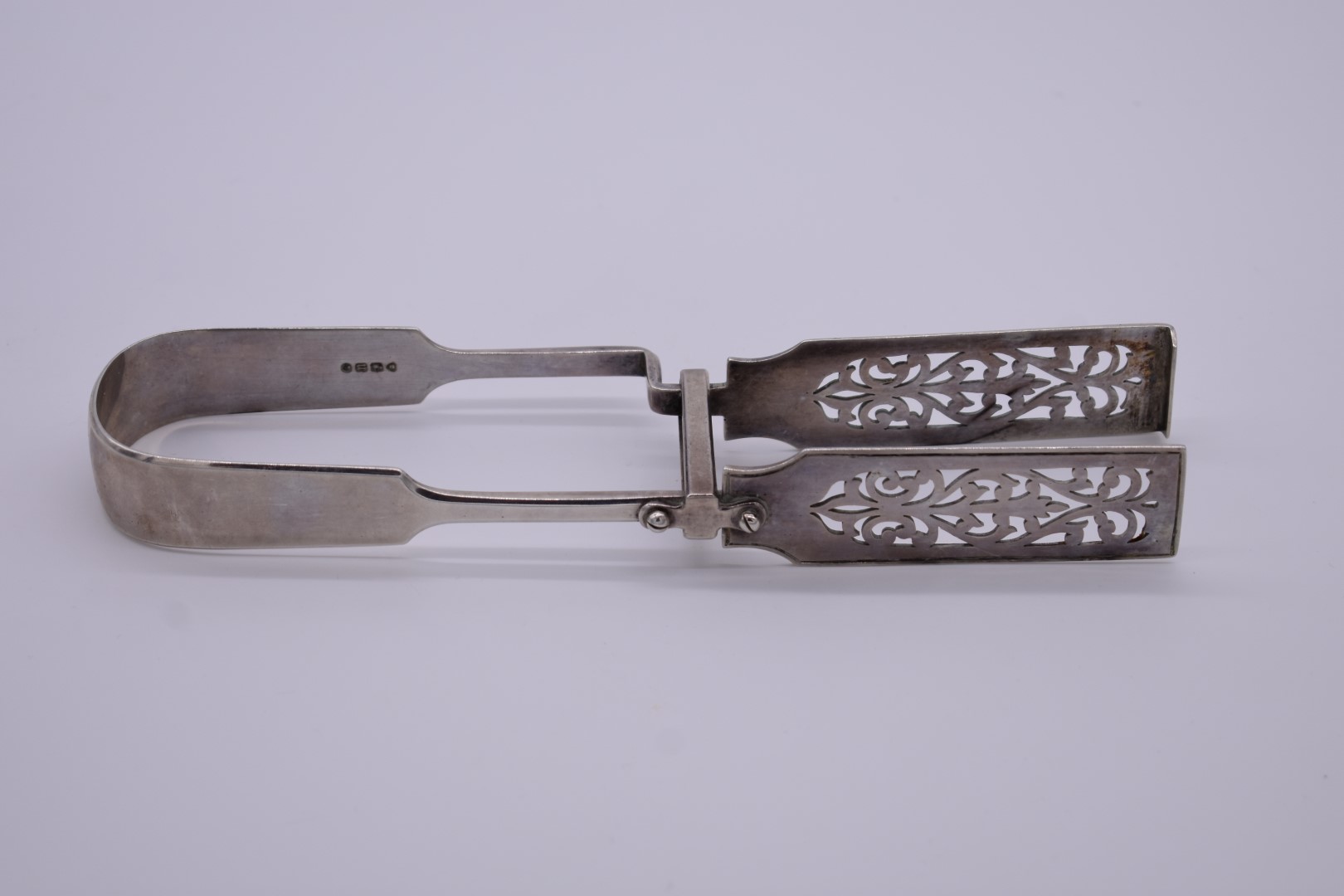 A pair of Victorian pierced silver asparagus tongs, by H J Lias & Son, London 1875, 22.5cm long,