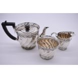 A Victorian silver three piece teaset, by Goldsmiths & Silversmiths Co (William Gibson & John
