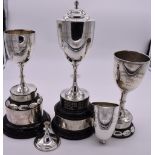 Three silver trophy cups, including a covered example; together with another (a.f), all having