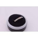 A channel set diamond half eternity platinum ring, hallmarked 950, 4.2g.