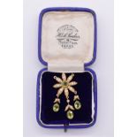 An Edwardian peridot and seed pearl floral pendant/brooch, unmarked, 4.5cm, 6.1g total weight.
