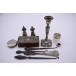A quantity of silver and silver mounted items, including: a .925 pig pin cushion; a candlestick; and