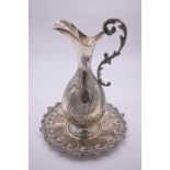 A large Continental embossed .900 ewer and stand, by B U, 39cm high, 1574g.